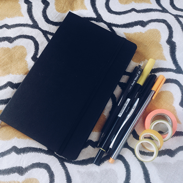 Image shows bullet journal and stationery items