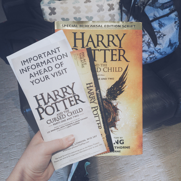 image shows a copy of Harry Potter and the Cursed Child script book along with tickets for Harry Potter and the Cursed Child